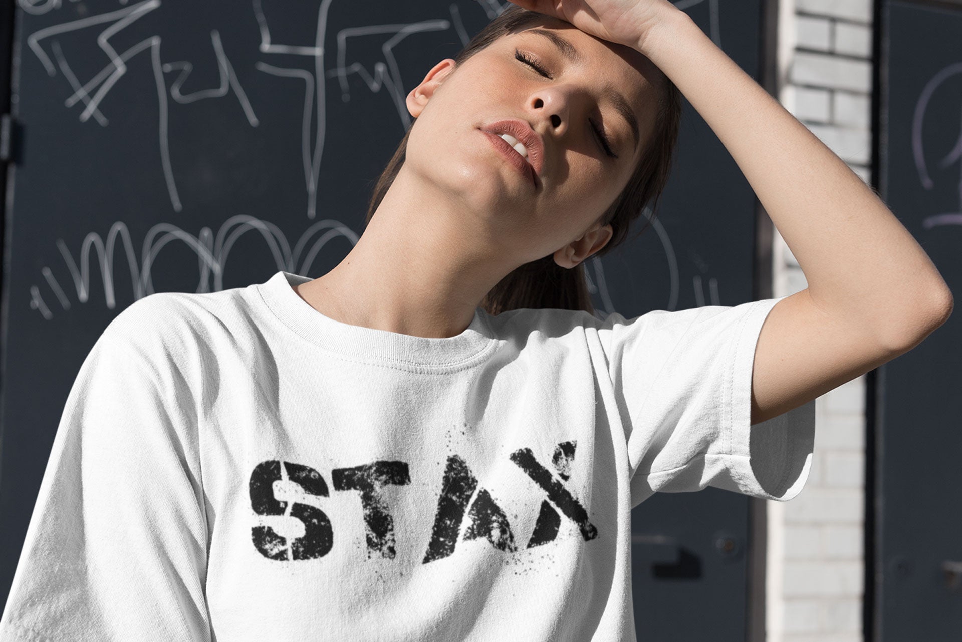 A young woman enjoying the sunshine wearing a Danny Tenaglia STAX t-shirt